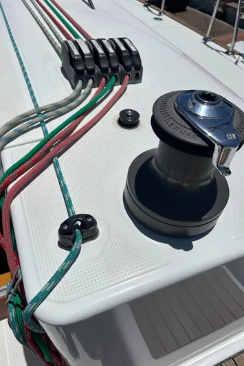 Pacifico Yacht Photos Pics Deck of 2005 Beneteau First 44.7 sailboat with winch and colorful ropes.