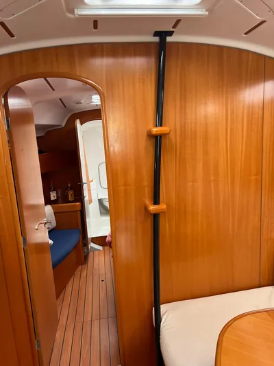 Pacifico Yacht Photos Pics Interior of 2005 Beneteau First 44.7 sailboat, featuring wooden paneling and seating area.