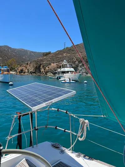 Pacifico Yacht Photos Pics Beneteau First 44.7 sailboat with solar panel, anchored in scenic bay, 2005 model.
