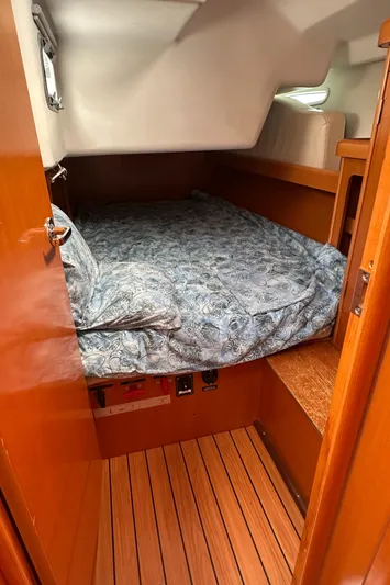 Pacifico Yacht Photos Pics Cozy cabin interior of 2005 Beneteau First 44.7 sailboat with wooden flooring.