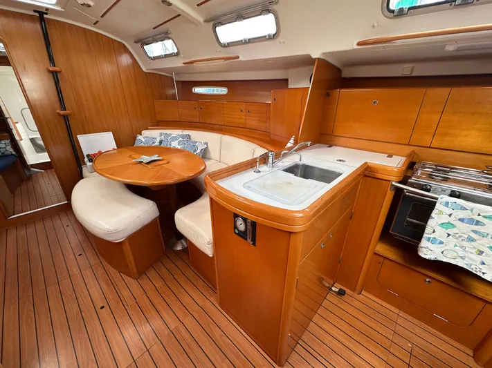 Pacifico Yacht Photos Pics Luxurious 2005 Beneteau First 44.7 yacht interior with wood finish and modern amenities.