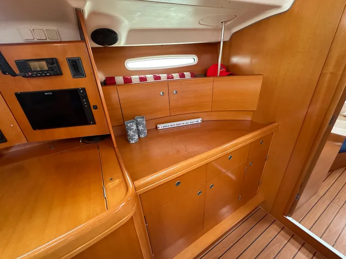 Pacifico Yacht Photos Pics Interior of 2005 Beneteau First 44.7 yacht with wooden cabinetry and modern amenities.