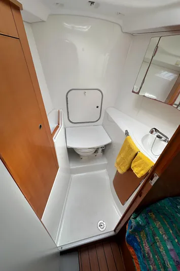 Pacifico Yacht Photos Pics Beneteau First 44.7 2005 yacht bathroom with toilet, sink, and mirror.