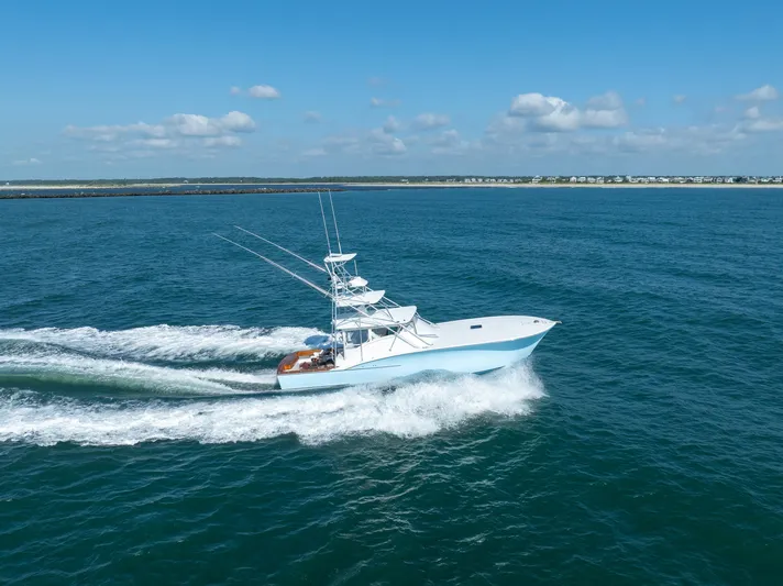 Break Time Yacht Photos Pics 2007 Custom Carolina Layton Express boat cruising on open water under a clear blue sky.