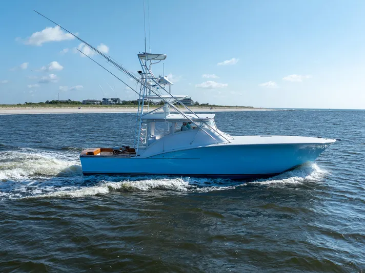 Break Time Yacht Photos Pics 2007 Custom Carolina Layton Express boat cruising on open water under a clear blue sky.