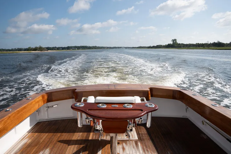 Break Time Yacht Photos Pics 2007 Custom Carolina Layton Express boat cruising on a sunny day, wooden deck and calm waters.