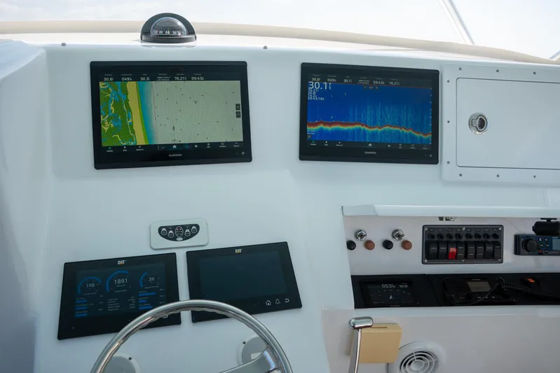 Break Time Yacht Photos Pics Control panel of 2007 Custom Carolina Layton Express boat with navigation and monitoring screens.