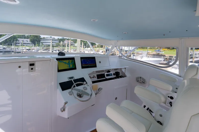 Break Time Yacht Photos Pics Interior of 2007 Custom Carolina Layton Express boat with modern navigation equipment and white seating.