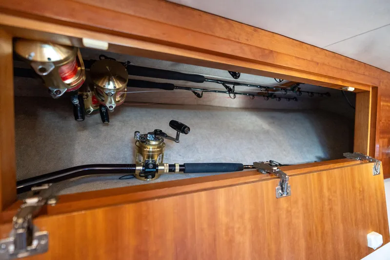 Break Time Yacht Photos Pics Fishing rods and reels stored in a wooden compartment on a 2007 Custom Carolina Layton Express boat.