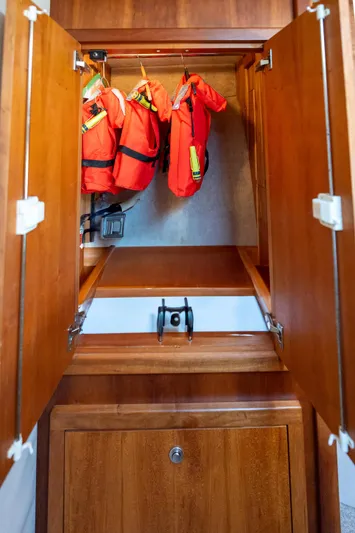 Break Time Yacht Photos Pics Wooden cabinet with life jackets inside, aboard a 2007 Custom Carolina Layton Express.