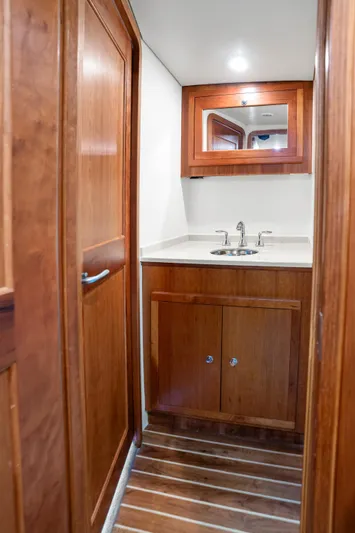 Break Time Yacht Photos Pics 2007 Custom Carolina Layton Express yacht bathroom with wooden cabinetry and modern sink.