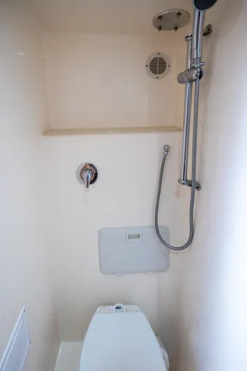 Break Time Yacht Photos Pics Compact bathroom in 2007 Custom Carolina Layton Express boat with shower and toilet.