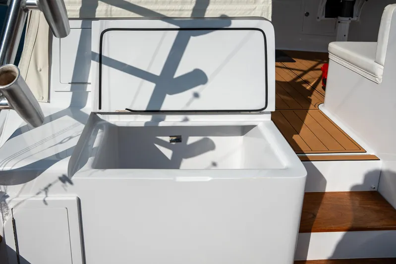 Break Time Yacht Photos Pics 2007 Custom Carolina Layton Express boat with open storage compartment and teak flooring.