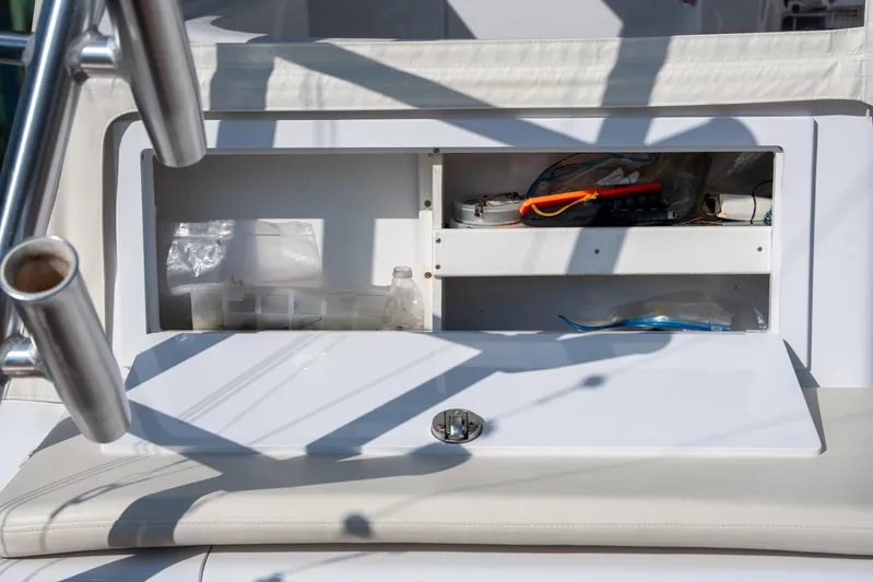 Break Time Yacht Photos Pics Open storage compartment on 2007 Custom Carolina Layton Express boat, containing various items.