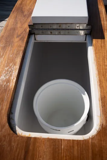 Break Time Yacht Photos Pics Open storage compartment on 2007 Custom Carolina Layton Express boat with wooden trim.