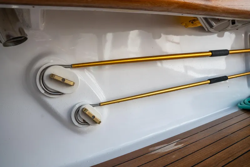 Break Time Yacht Photos Pics 2007 Custom Carolina Layton Express boat interior with gold rods and wooden deck.