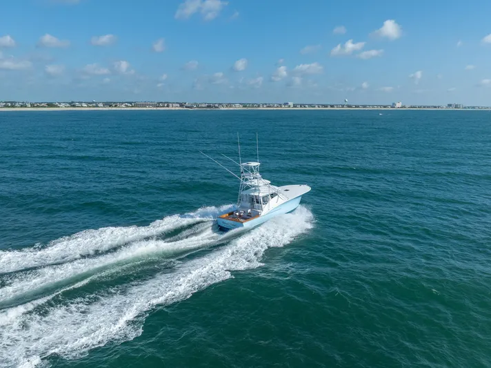 Break Time Yacht Photos Pics 2007 Custom Carolina Layton Express cruising on open ocean under clear blue sky.