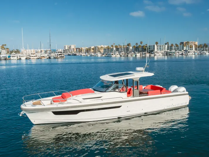 Intrepid Yacht Photos Pics 2021 Nimbus T11 boat on calm water with marina background.