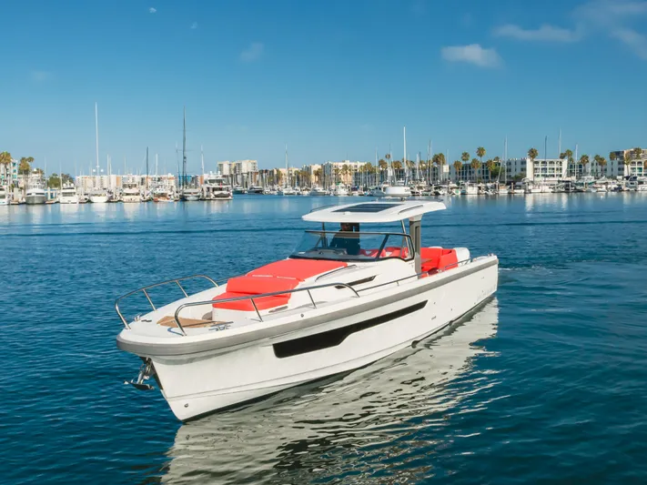Intrepid Yacht Photos Pics 2021 Nimbus T11 boat cruising in a marina with clear blue skies.