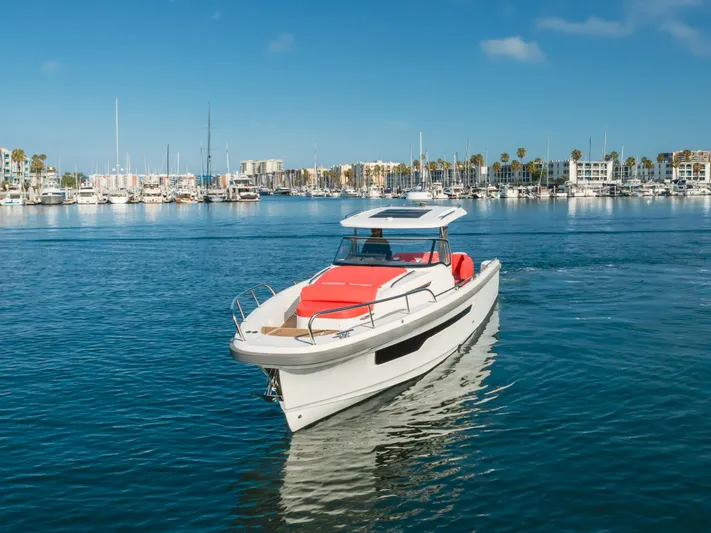 Intrepid Yacht Photos Pics Nimbus T11 2021 boat cruising in a marina with clear blue skies.