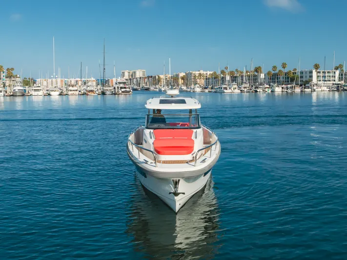 Intrepid Yacht Photos Pics 2021 Nimbus T11 boat in marina, clear blue sky, calm water, cityscape background.