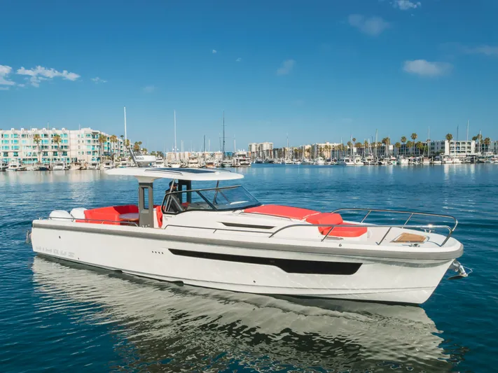 Intrepid Yacht Photos Pics Nimbus T11 2021 boat cruising in a marina with clear blue skies.