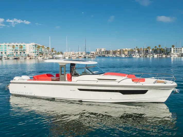 Intrepid Yacht Photos Pics 2021 Nimbus T11 boat cruising in a marina with clear blue skies.