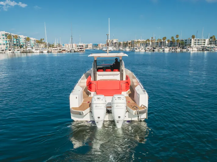 Intrepid Yacht Photos Pics Nimbus T11 2021 boat cruising in a marina with clear blue skies.