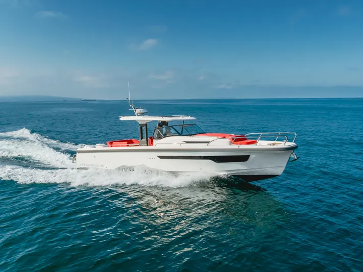 Intrepid Yacht Photos Pics Nimbus T11 2021 motorboat cruising on open sea under clear blue sky.