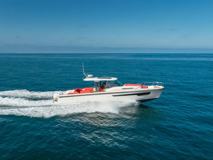 Intrepid Yacht Photos Pics 2021 Nimbus T11 boat cruising on open sea under clear blue sky.