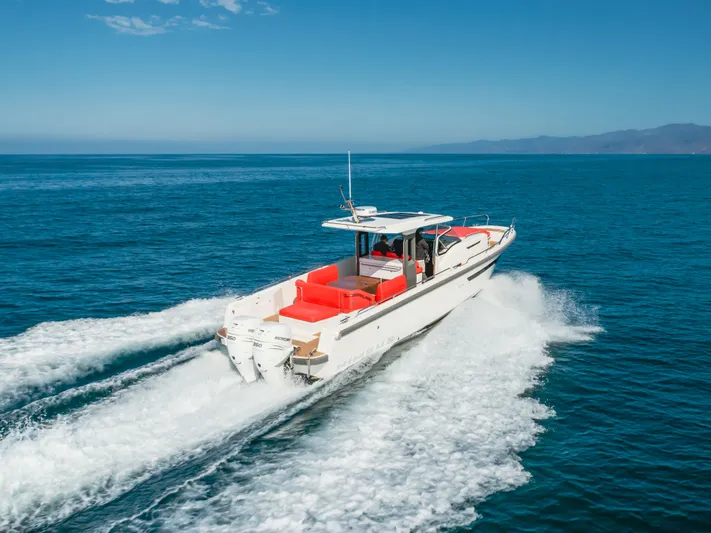 Intrepid Yacht Photos Pics 2021 Nimbus T11 boat cruising on open sea with clear blue skies.