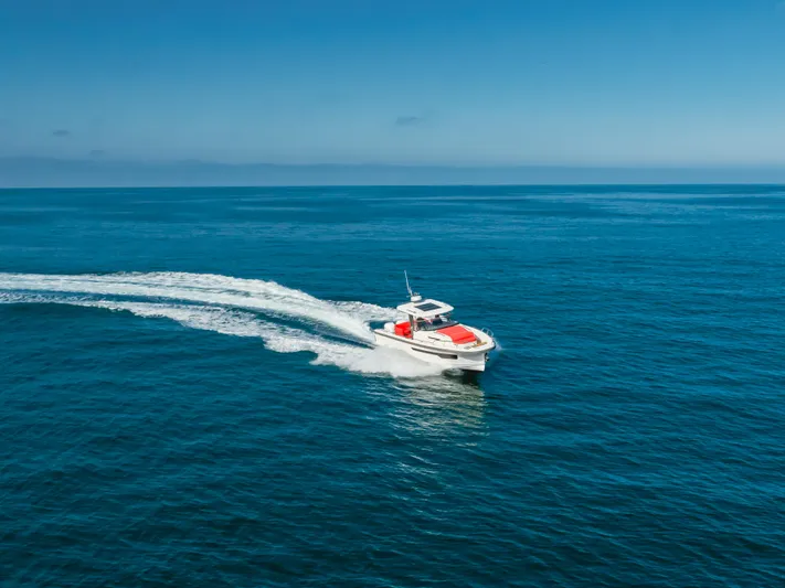 Intrepid Yacht Photos Pics 2021 Nimbus T11 boat cruising on open blue ocean under clear sky.