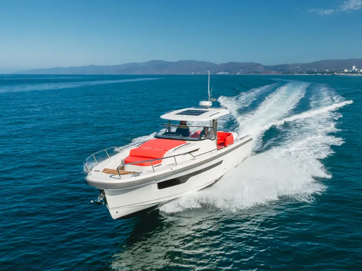 Intrepid Yacht Photos Pics Nimbus T11 2021 motorboat cruising on open sea with clear blue skies.