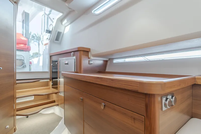 Intrepid Yacht Photos Pics Luxurious interior of 2021 Nimbus T11 boat with wooden cabinetry and modern design.
