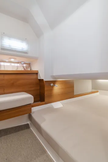 Intrepid Yacht Photos Pics Modern interior of 2021 Nimbus T11 boat with wooden accents and cozy seating.