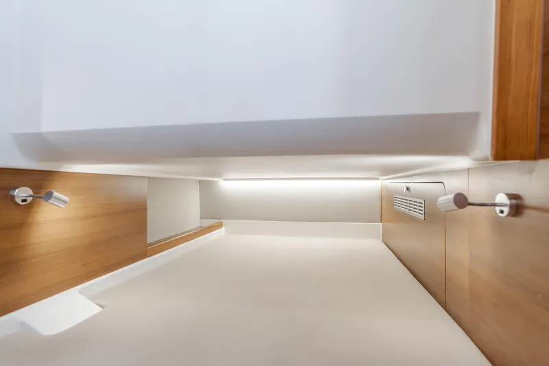 Intrepid Yacht Photos Pics Modern interior of 2021 Nimbus T11 boat with sleek wood paneling and ambient lighting.