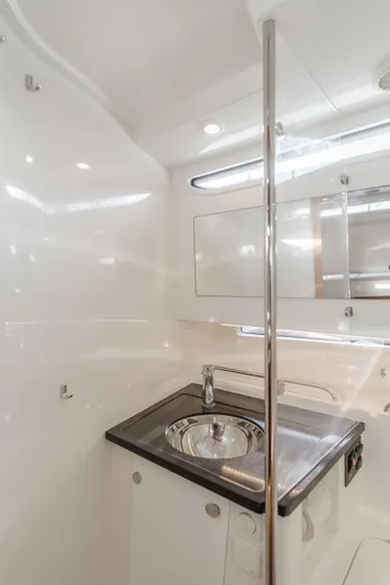 Intrepid Yacht Photos Pics Modern bathroom interior in 2021 Nimbus T11 boat, featuring sleek sink and mirror.