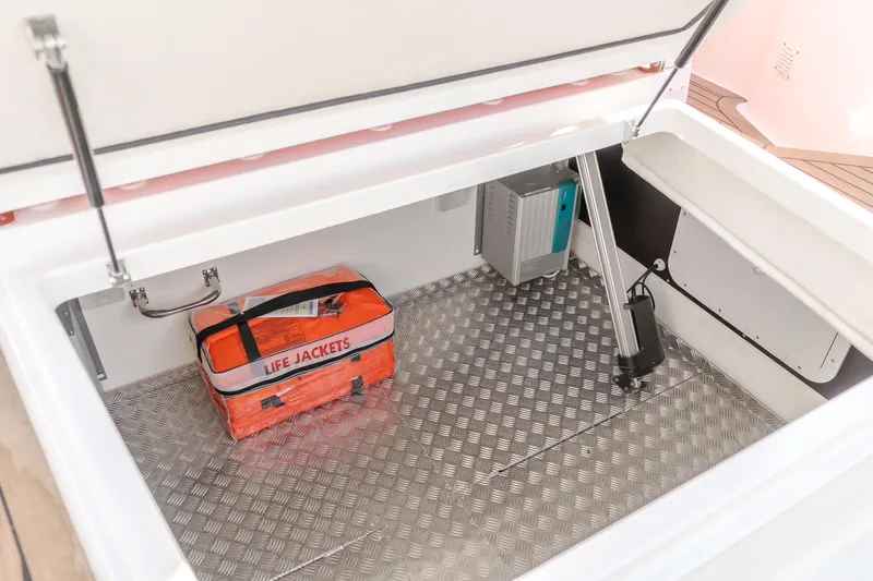 Intrepid Yacht Photos Pics Storage compartment in 2021 Nimbus T11 boat with life jackets and hydraulic lift.