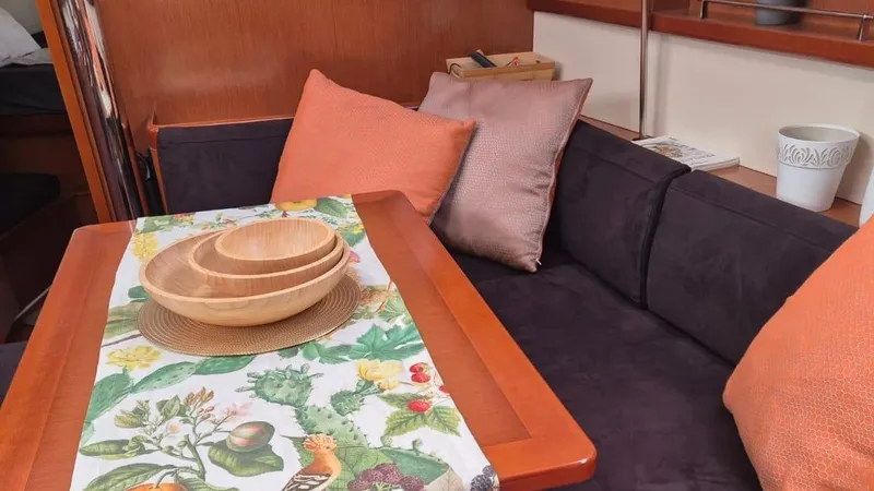 1702 Yacht Photos Pics Interior of 2010 Beneteau Oceanis 43 with cozy seating and decorative table setting.