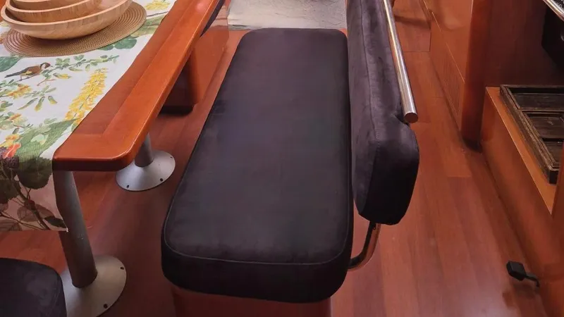 1702 Yacht Photos Pics Interior of 2010 Beneteau Oceanis 43 yacht with dining area and cushioned seating.