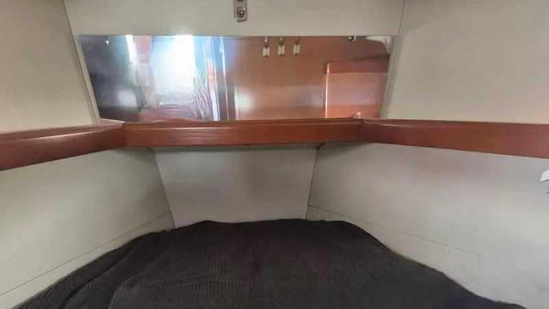 1702 Yacht Photos Pics Interior cabin of 2010 Beneteau Oceanis 43 sailboat with wooden trim and mirror.