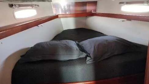 1702 Yacht Photos Pics Cozy cabin interior of 2010 Beneteau Oceanis 43 sailboat with double bed and pillows.