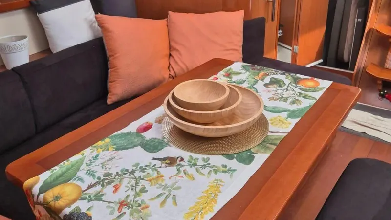 1702 Yacht Photos Pics Interior of 2010 Beneteau Oceanis 43 yacht with decorative table setting and cushions.