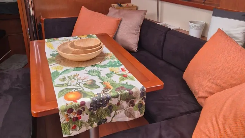 1702 Yacht Photos Pics Interior of 2010 Beneteau Oceanis 43 with cozy seating and decorative table setting.