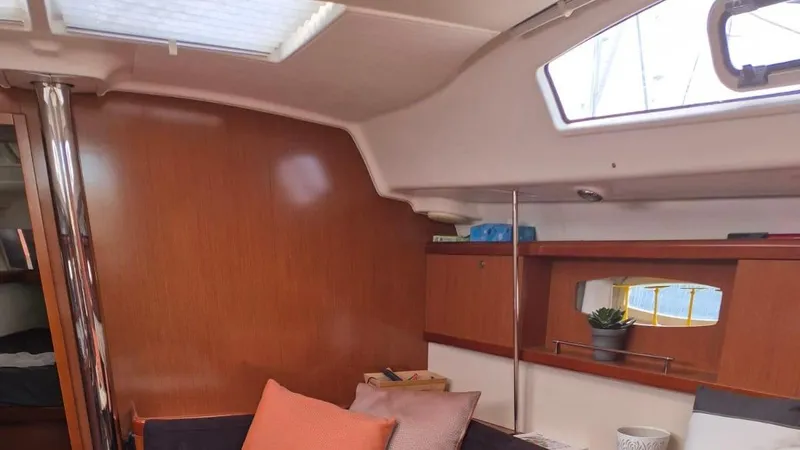 1702 Yacht Photos Pics Interior of 2010 Beneteau Oceanis 43 sailboat with cozy seating and wooden finishes.
