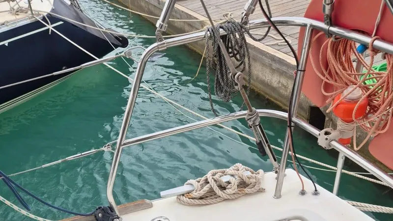 1702 Yacht Photos Pics Beneteau Oceanis 43 sailboat deck with ropes and safety equipment, docked at marina.