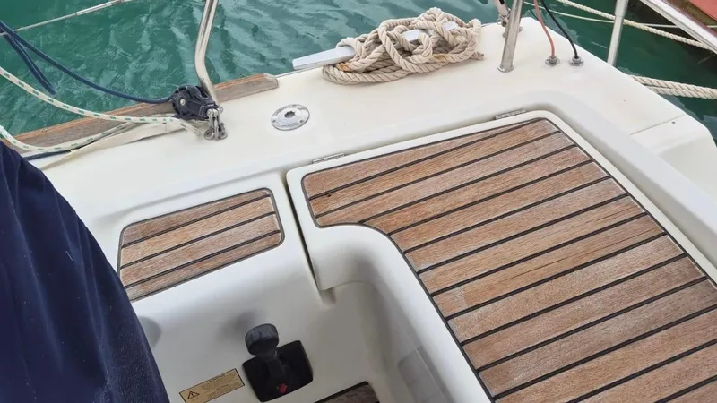 1702 Yacht Photos Pics Beneteau Oceanis 43 sailboat deck, 2010 model, featuring teak wood finish and mooring ropes.