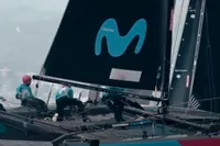 Sailboat with crew racing, featuring prominent blue logo on sail, 2012 GC model 32.