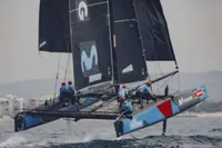 Sailing catamaran GC 32 from 2012 racing on open water with crew onboard.