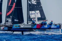 Sailing team racing on GC 32 catamaran, 2012 model, in vibrant blue ocean.